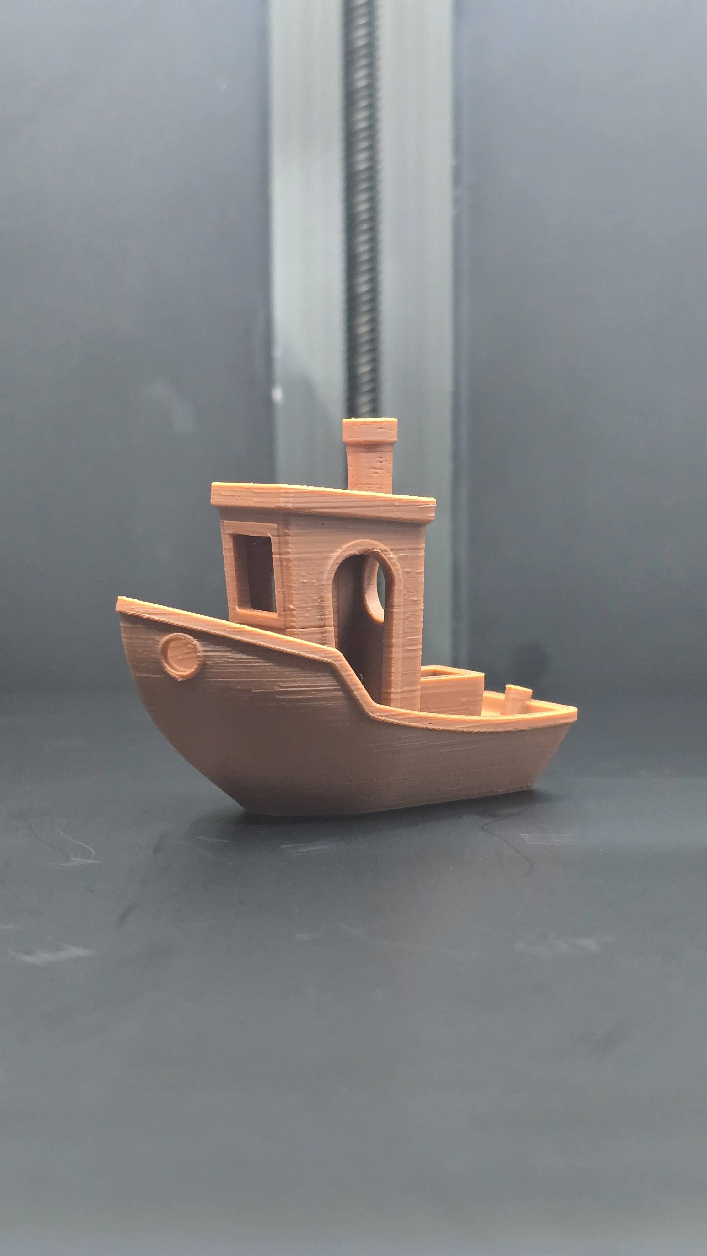 Angled view of a freshly printed Benchy showing PLA surface finish and detail quality
