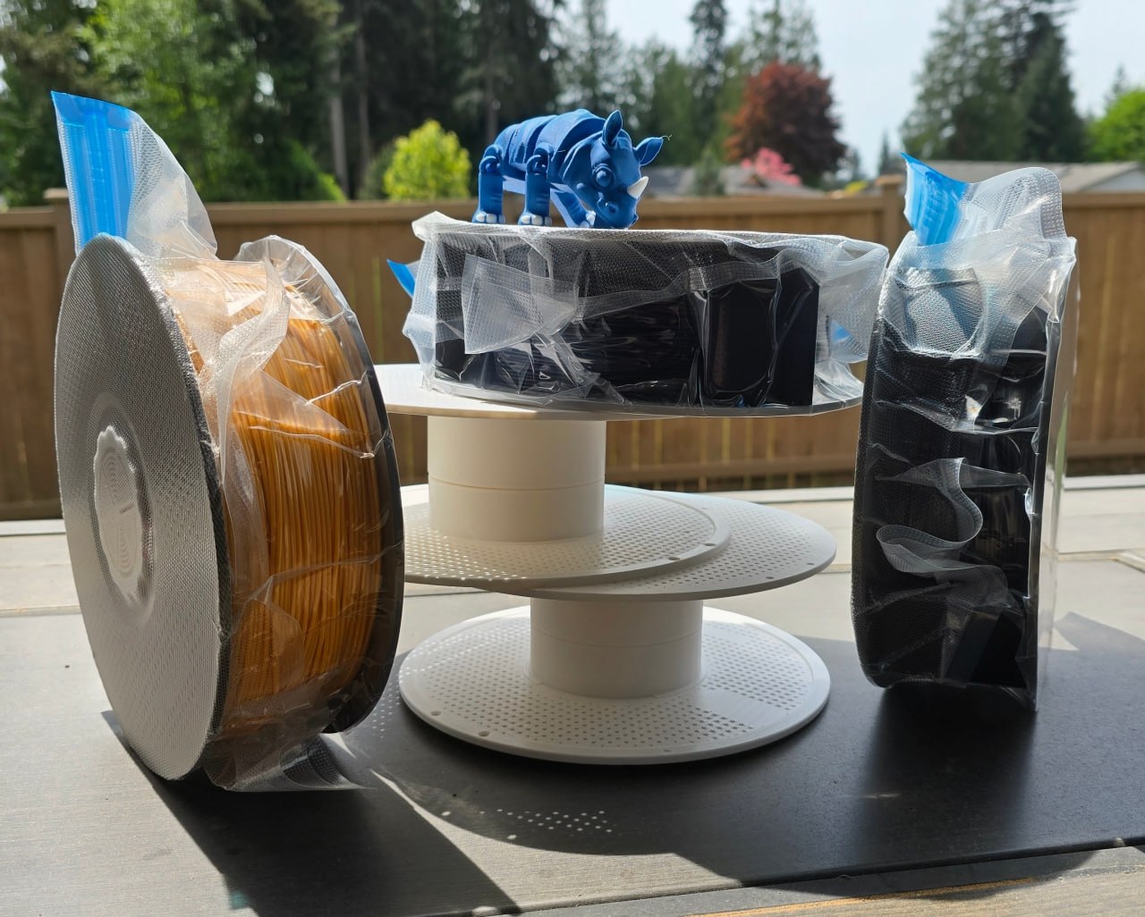 Filament spools on a spool stand with a 3D printed rhino